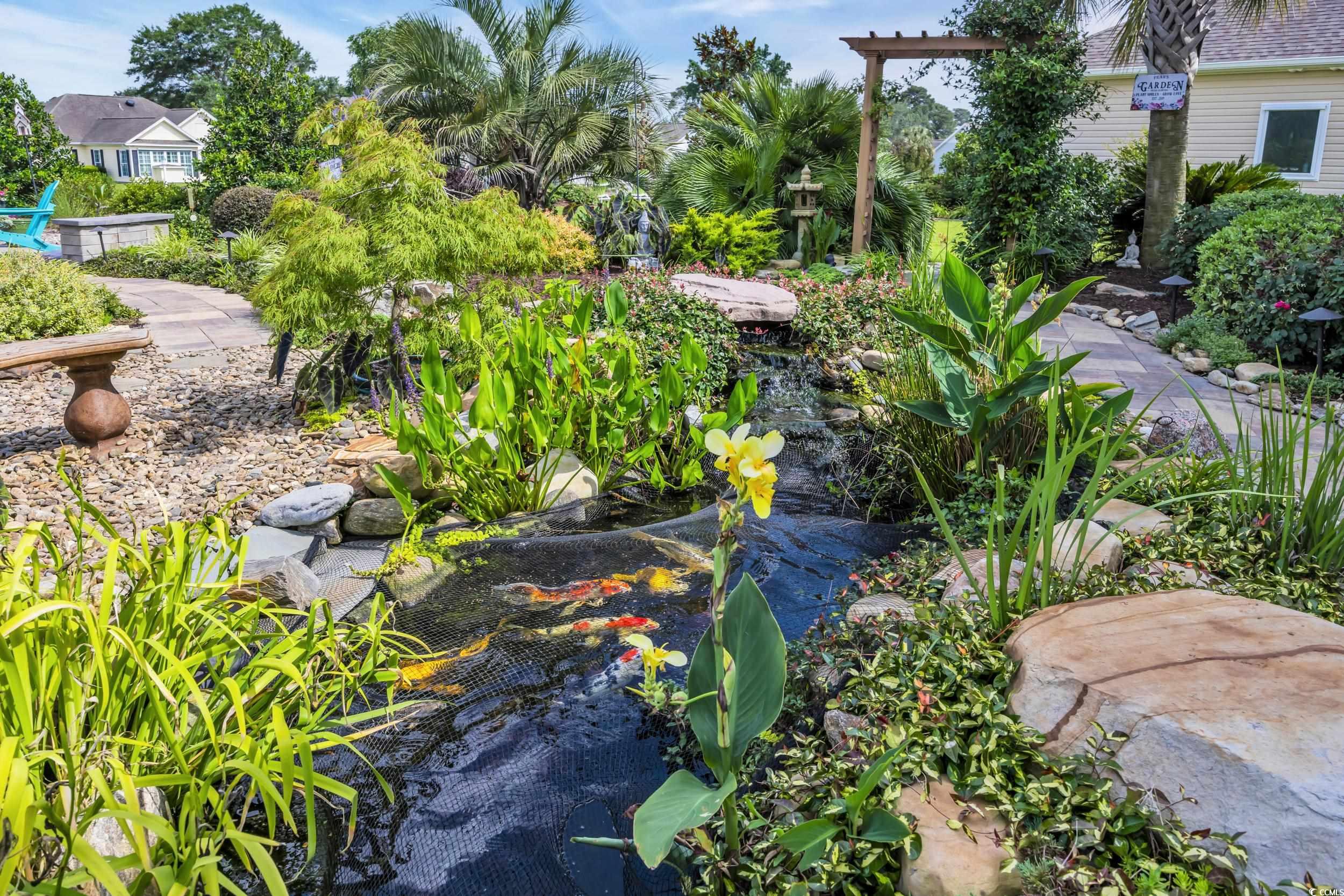 925 Abernathy Place Surfside Beach, SC 29575 - Photo 25 of 40 View of yard with a garden pond