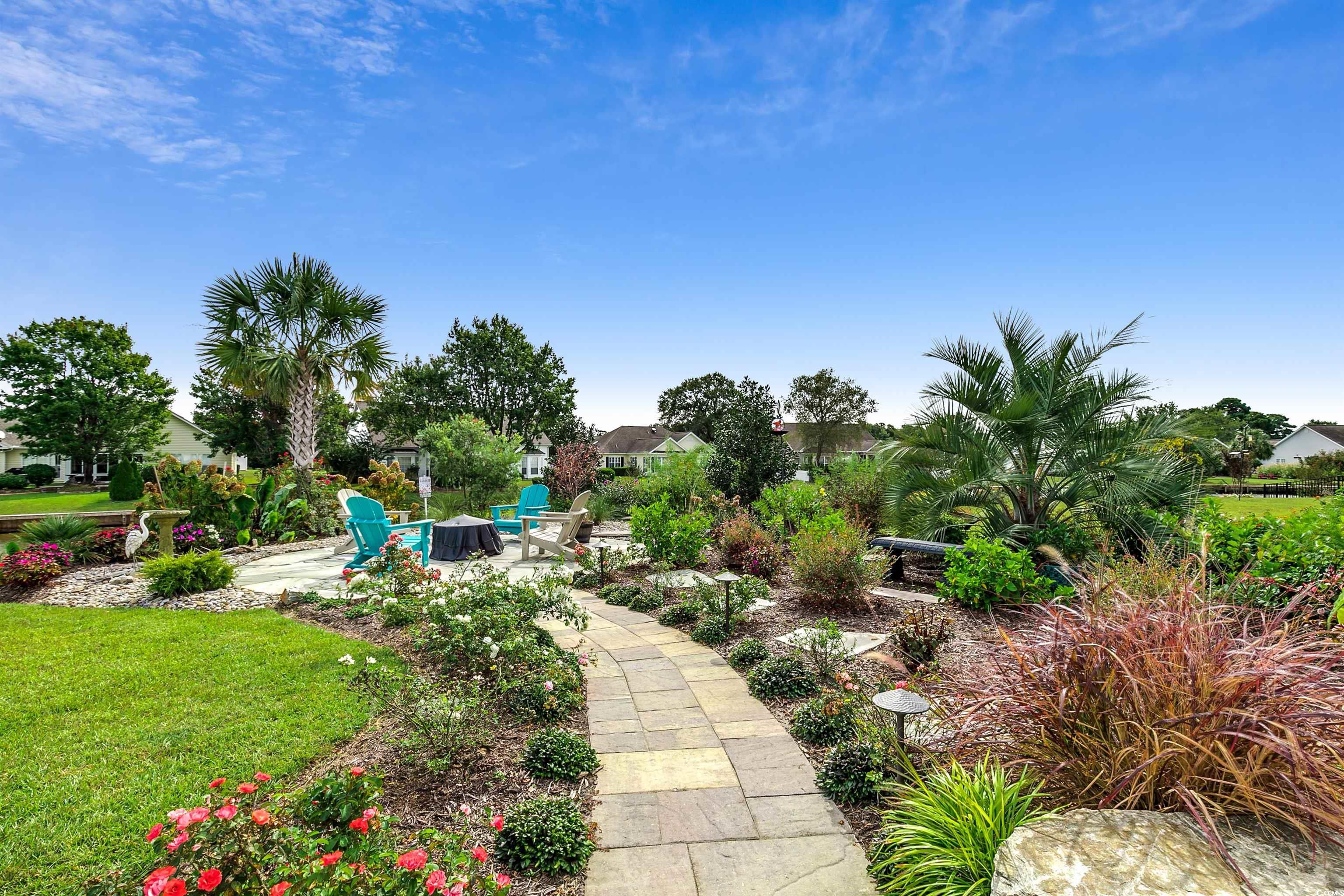 925 Abernathy Place Surfside Beach, SC 29575 - Photo 26 of 40 View of green lawn with a patio