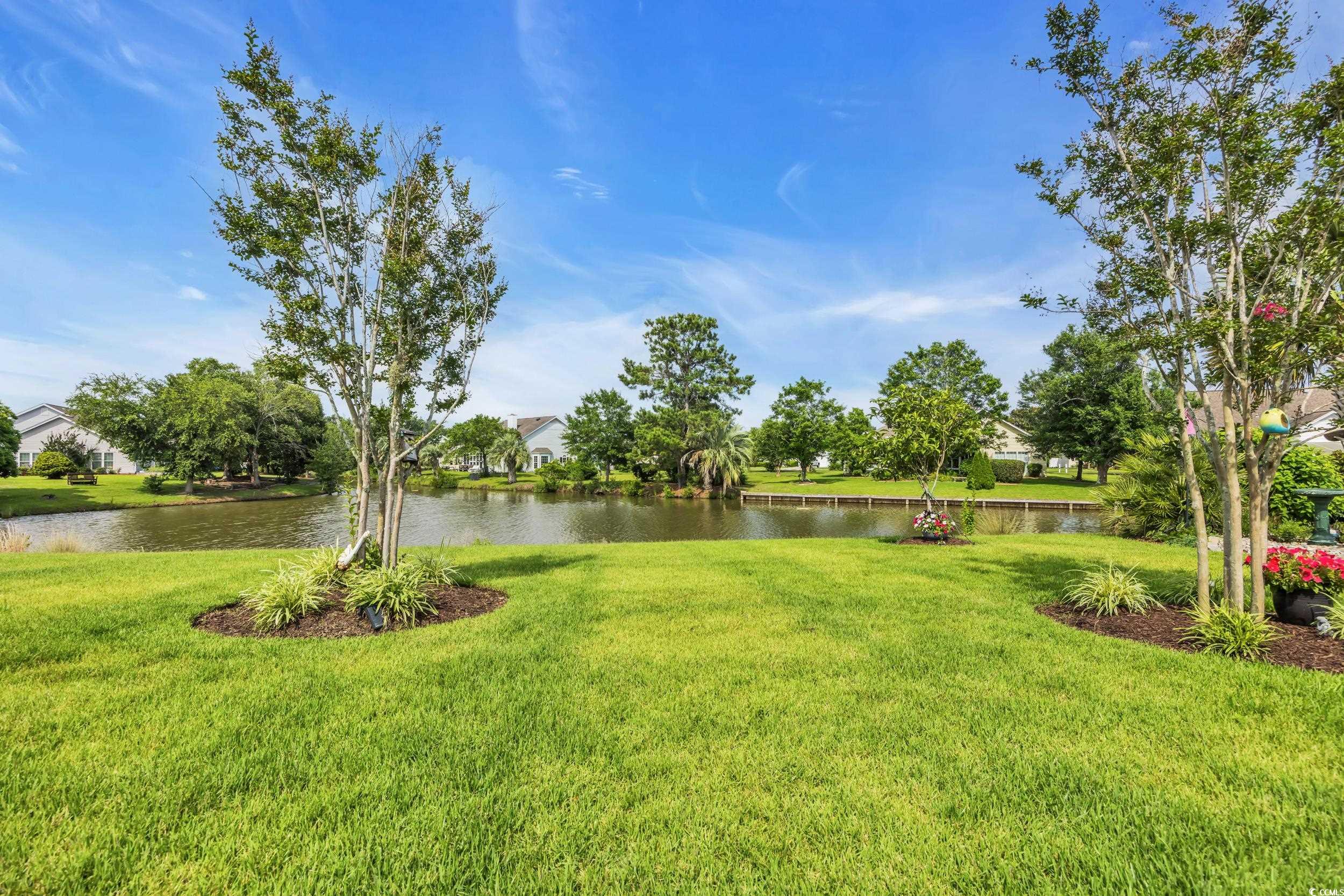 925 Abernathy Place Surfside Beach, SC 29575 - Photo 29 of 40 View of green lawn featuring a water view