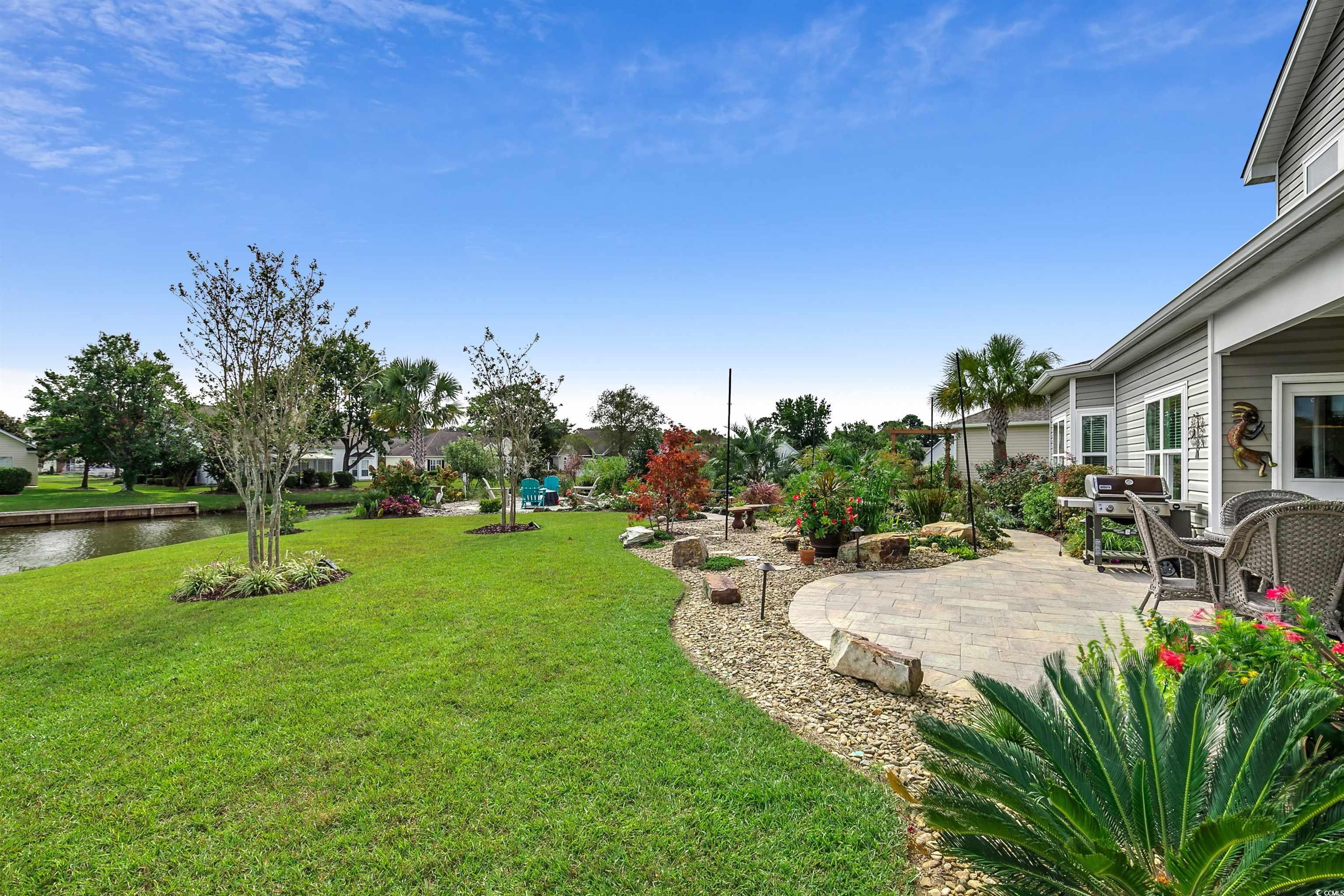 925 Abernathy Place Surfside Beach, SC 29575 - Photo 32 of 40 View of grassy yard featuring a patio and a water