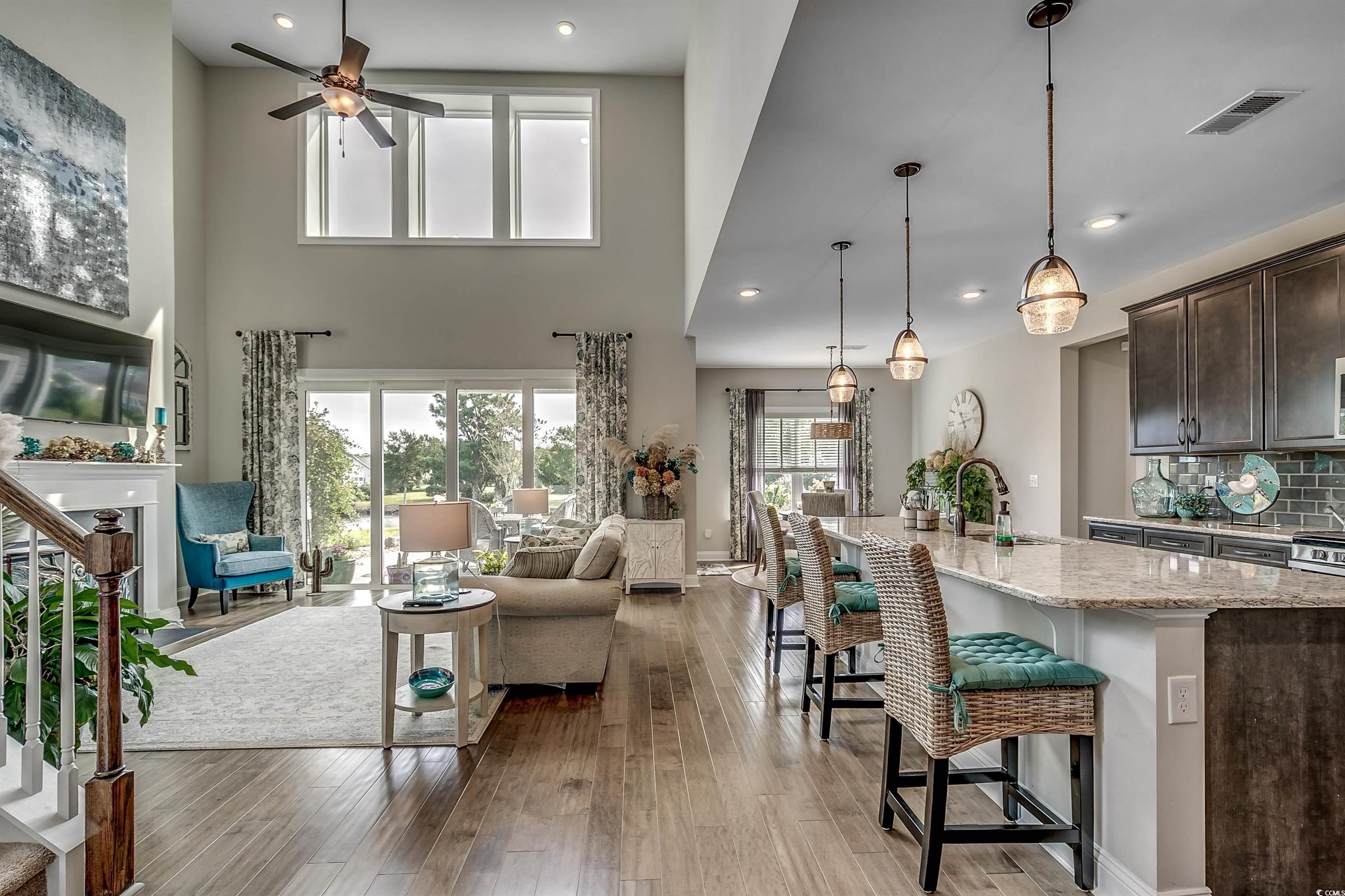 925 Abernathy Place Surfside Beach, SC 29575 - Photo 5 of 40 Living area with ceiling fan, light wood-style flo