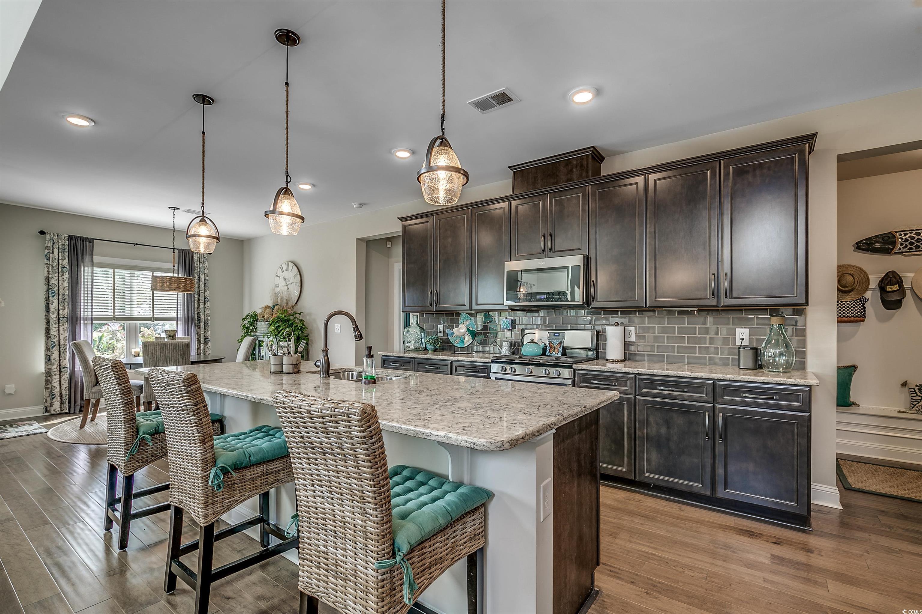 925 Abernathy Place Surfside Beach, SC 29575 - Photo 6 of 40 Kitchen with stainless steel appliances, a sink, w