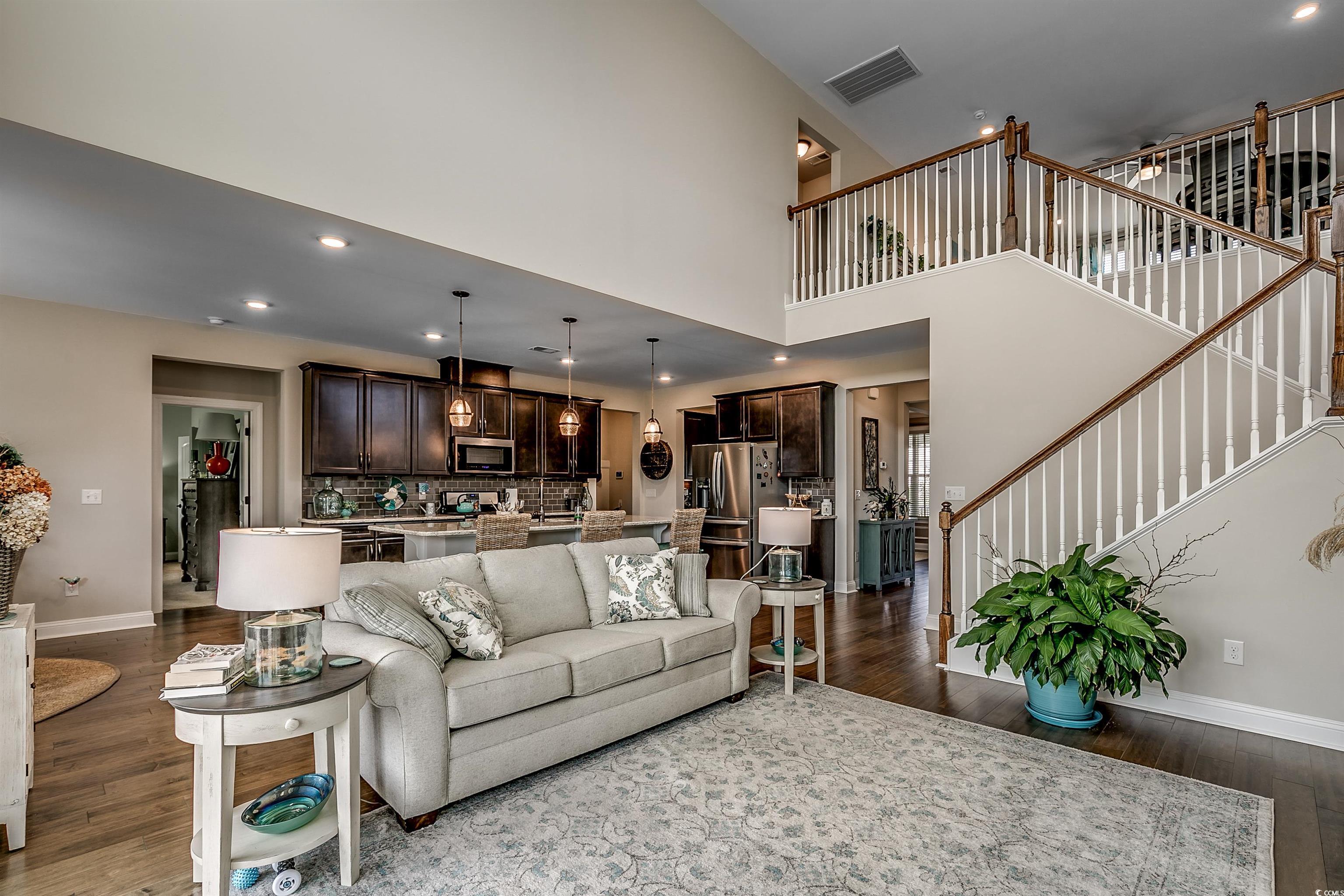 925 Abernathy Place Surfside Beach, SC 29575 - Photo 9 of 40 Living room with dark wood-style flooring, stairwa
