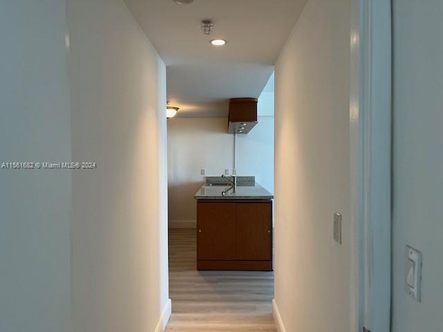 185 Southwest 7th Street, Unit 1403 Miami, FL 33130 - Photo 12 of 31 a kitchen with stainless steel appliances granite countertop a sink and a refrigerator