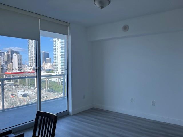 185 Southwest 7th Street, Unit 1403 Miami, FL 33130 - Photo 14 of 31 a view of a room with wooden floor and windows