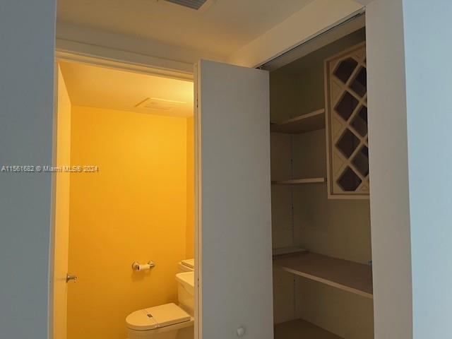 185 Southwest 7th Street, Unit 1403 Miami, FL 33130 - Photo 16 of 31 a bathroom with a granite countertop sink and a toilet