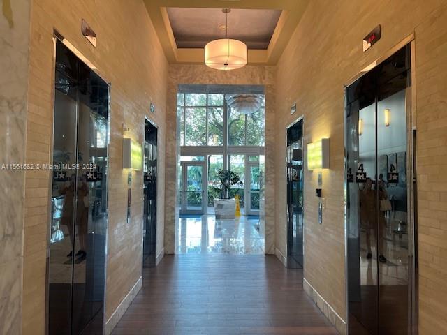 185 Southwest 7th Street, Unit 1403 Miami, FL 33130 - Photo 20 of 31 a view of a hallway with wooden floor and a bathroom
