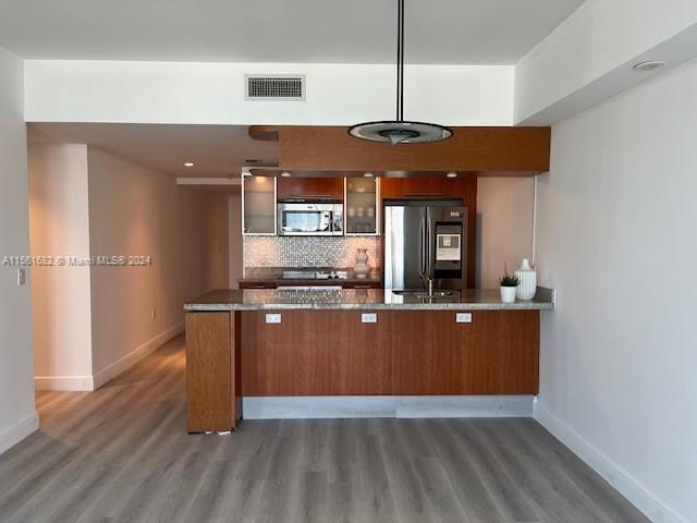 185 Southwest 7th Street, Unit 1403 Miami, FL 33130 - Photo 2 of 31 a kitchen with stainless steel appliances granite countertop a stove a refrigerator and a wooden floors