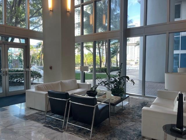 185 Southwest 7th Street, Unit 1403 Miami, FL 33130 - Photo 25 of 31 a living room with furniture and a floor to ceiling window