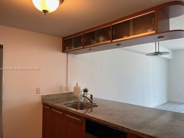 185 Southwest 7th Street, Unit 1403 Miami, FL 33130 - Photo 4 of 31 a kitchen with a sink and cabinets