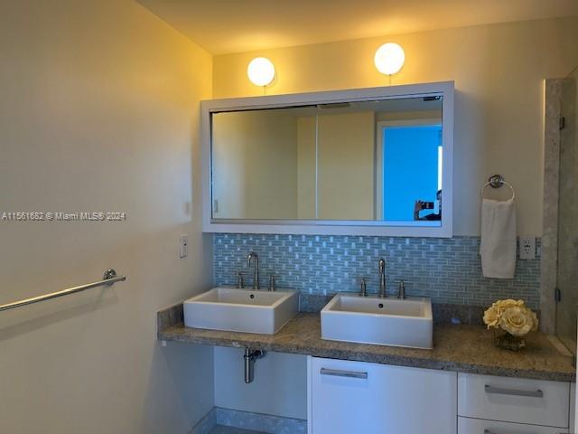185 Southwest 7th Street, Unit 1403 Miami, FL 33130 - Photo 9 of 31 a bathroom with a sink and a mirror