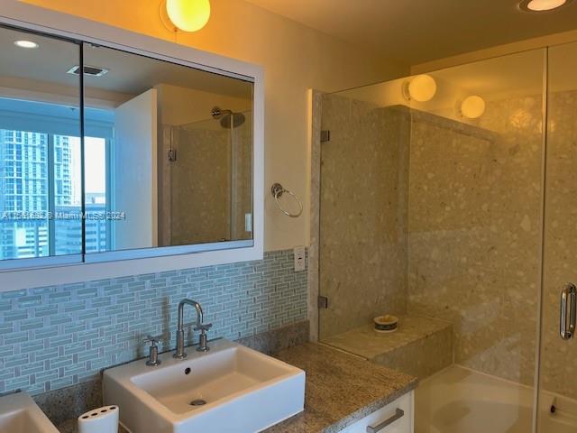 185 Southwest 7th Street, Unit 1403 Miami, FL 33130 - Photo 10 of 31 a bathroom with a sink shower and a mirror