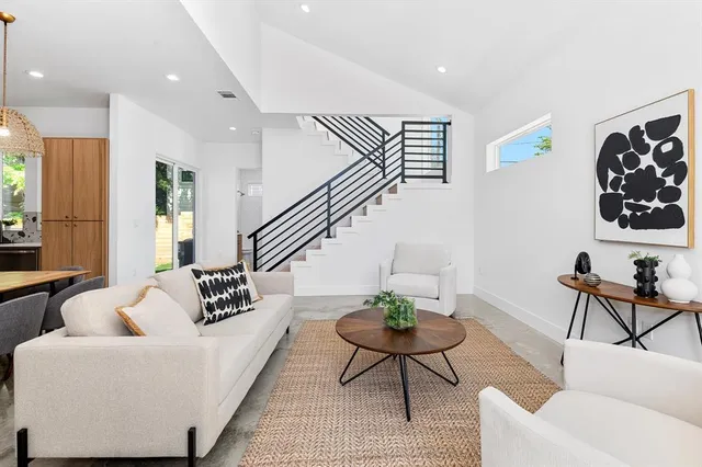 a living room with furniture and wooden floor