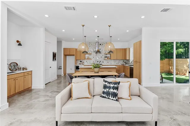 a living room with kitchen island furniture and a kitchen view