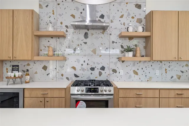 a kitchen with a stove and cabinets