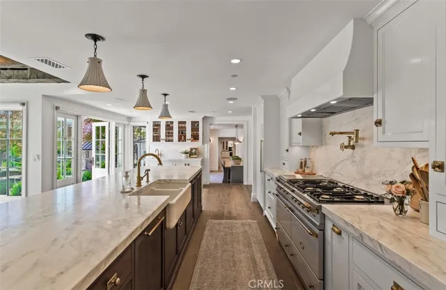 a kitchen with stove and cabinets