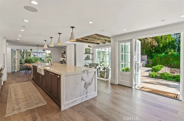 a kitchen with kitchen island wooden floor and window