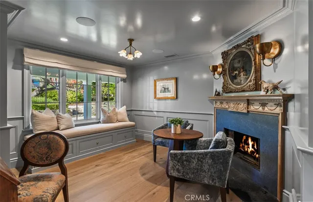 a living room with furniture a rug and a floor to ceiling window