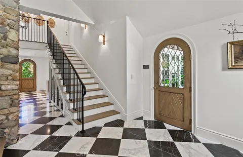 a view of a hallway with a black and white checkered floor