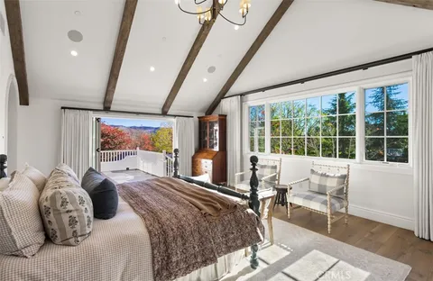 a bedroom with a large bed and a large window