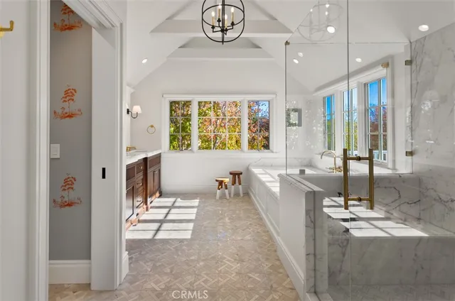 a very nice looking room with a large window and chandelier