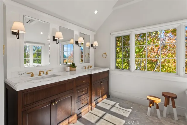 a bathroom with a double vanity sink a mirror and a bathtub