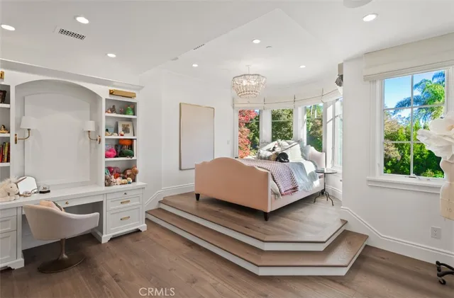 a bedroom with a bed wooden floor and window