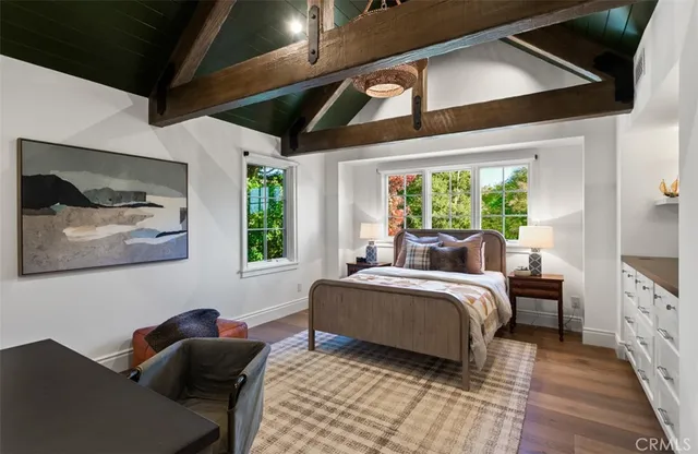 a bed room with a bed and a painting on the wall