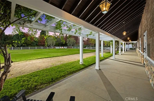 a view of a house with a big yard and potted plants