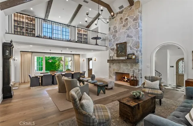a living room with furniture fireplace and a large window