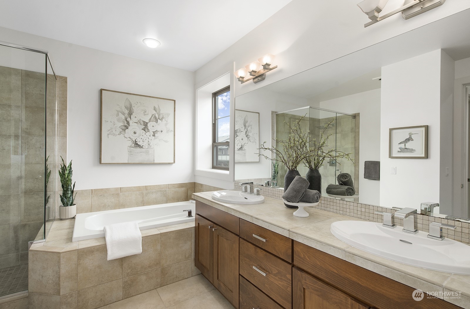 1229 North 42nd Place Renton, WA 98056 - Photo 25 of 40 a bathroom with double vanity sinks a large mirror and a bath tub