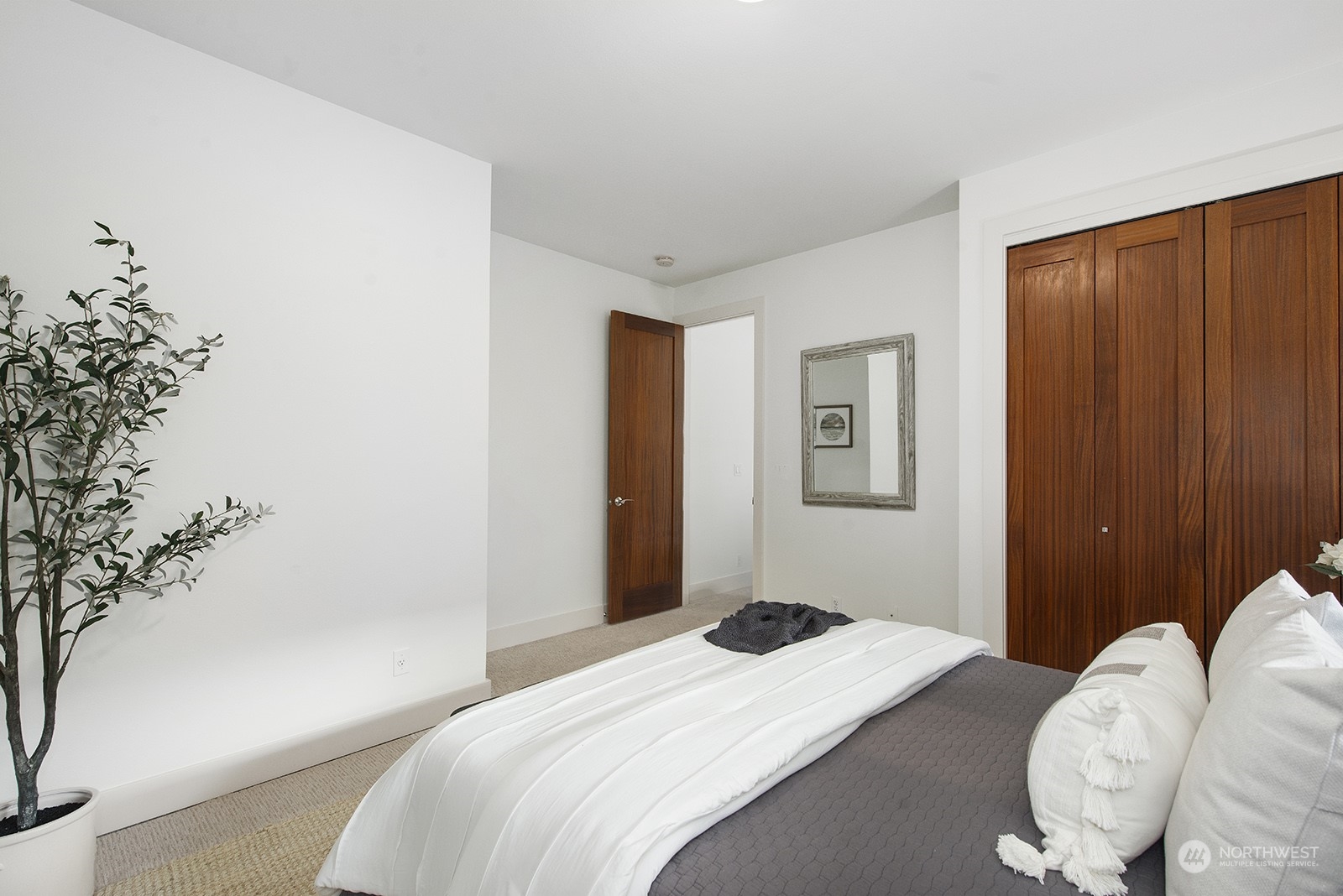1229 North 42nd Place Renton, WA 98056 - Photo 32 of 40 a bedroom with bed and a potted plant