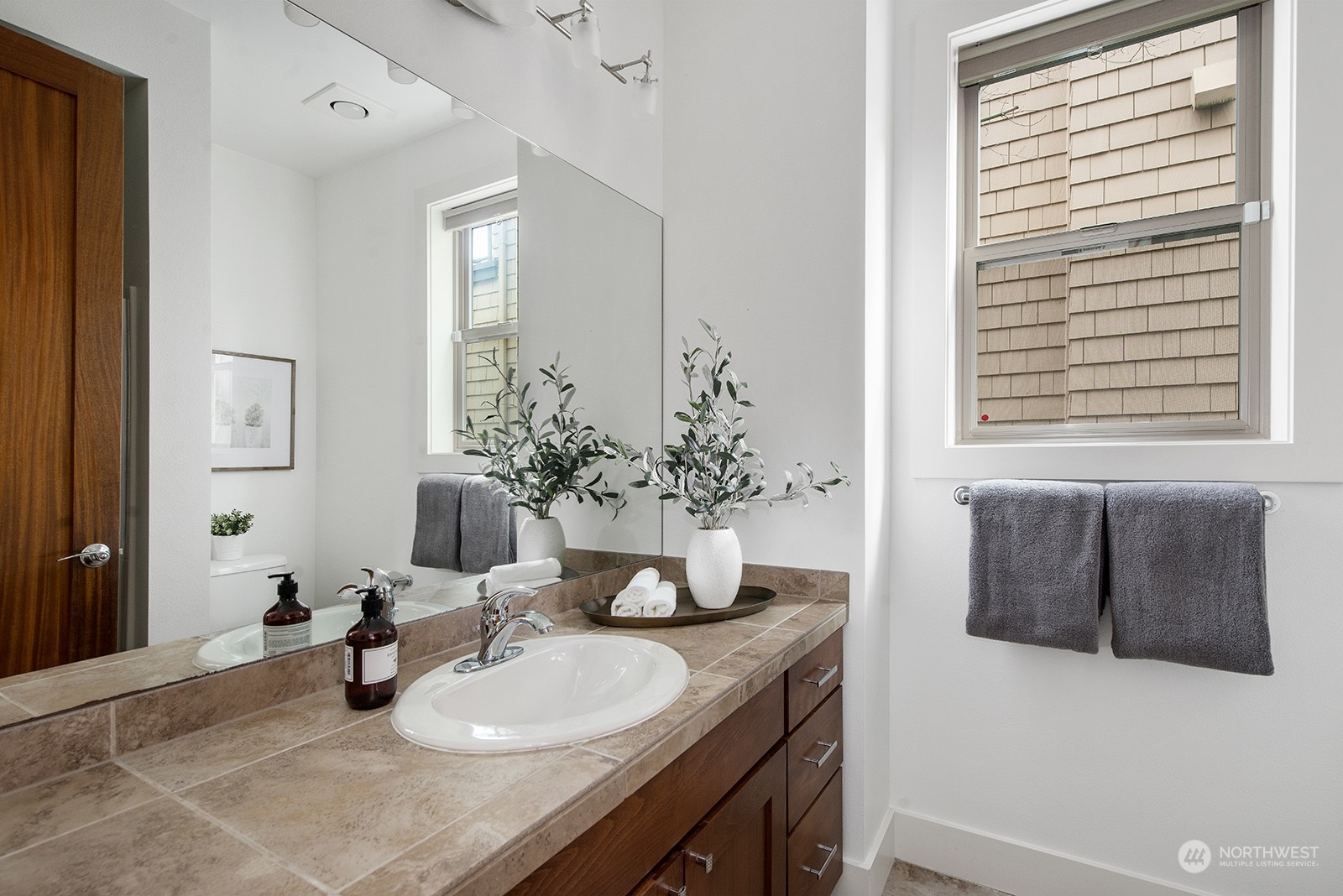 1229 North 42nd Place Renton, WA 98056 - Photo 33 of 40 a bathroom with a granite countertop sink and a mirror