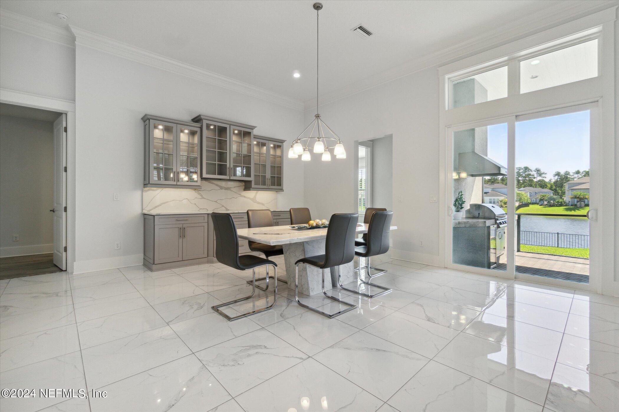 522 Old Bluff Drive Ponte Vedra, FL 32081 - Photo 16 of 93 a view of a dining room with furniture a chandelier and wooden floor
