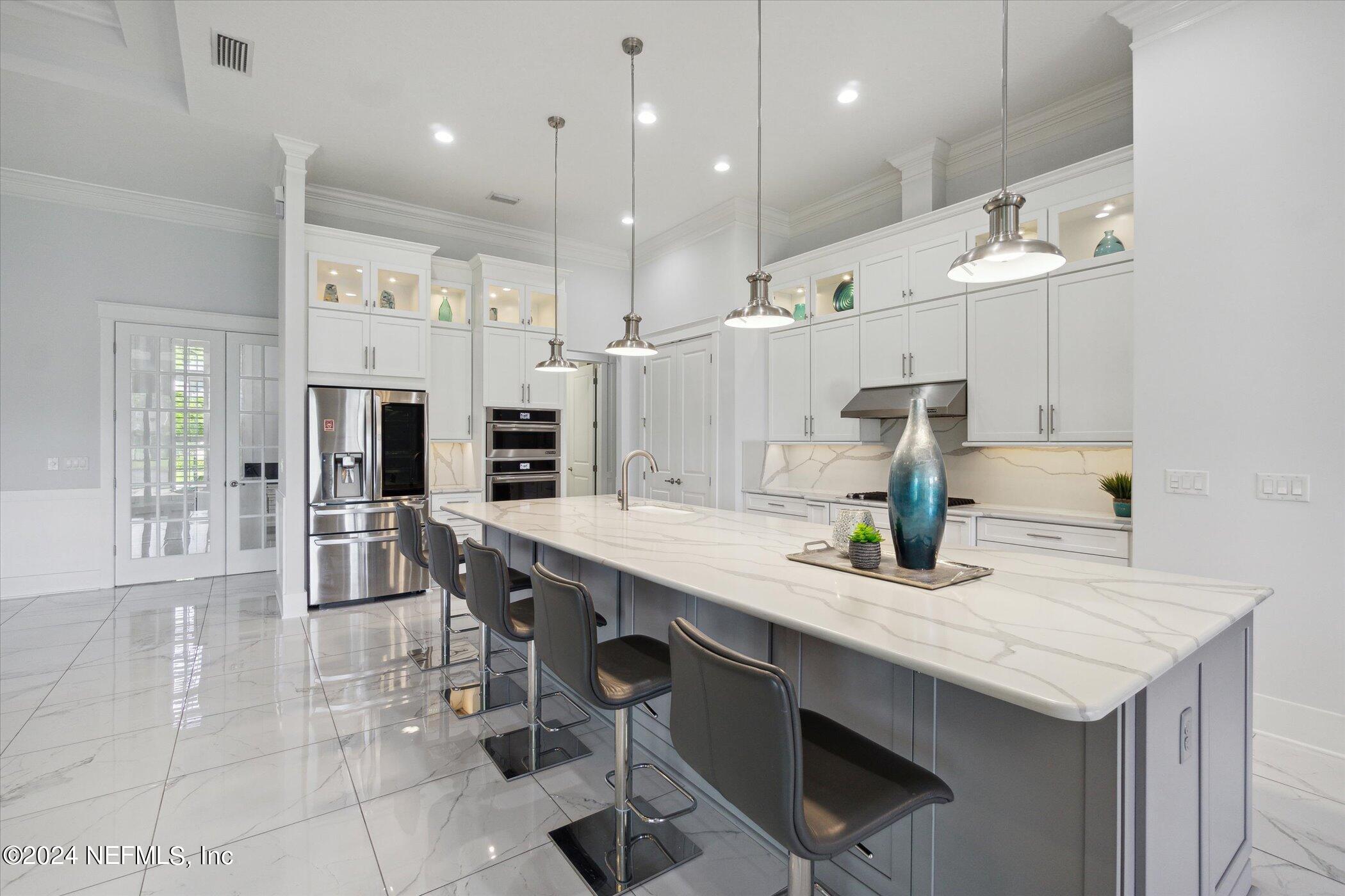 522 Old Bluff Drive Ponte Vedra, FL 32081 - Photo 19 of 93 a kitchen with stainless steel appliances granite countertop a sink a stove and a wooden floors
