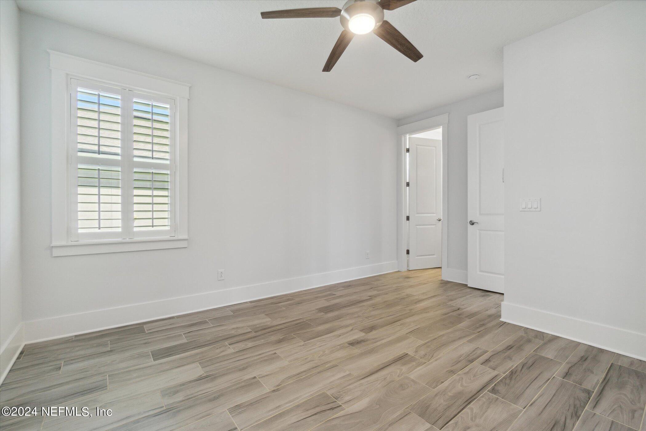 522 Old Bluff Drive Ponte Vedra, FL 32081 - Photo 49 of 93 an empty room with wooden floor fan and windows