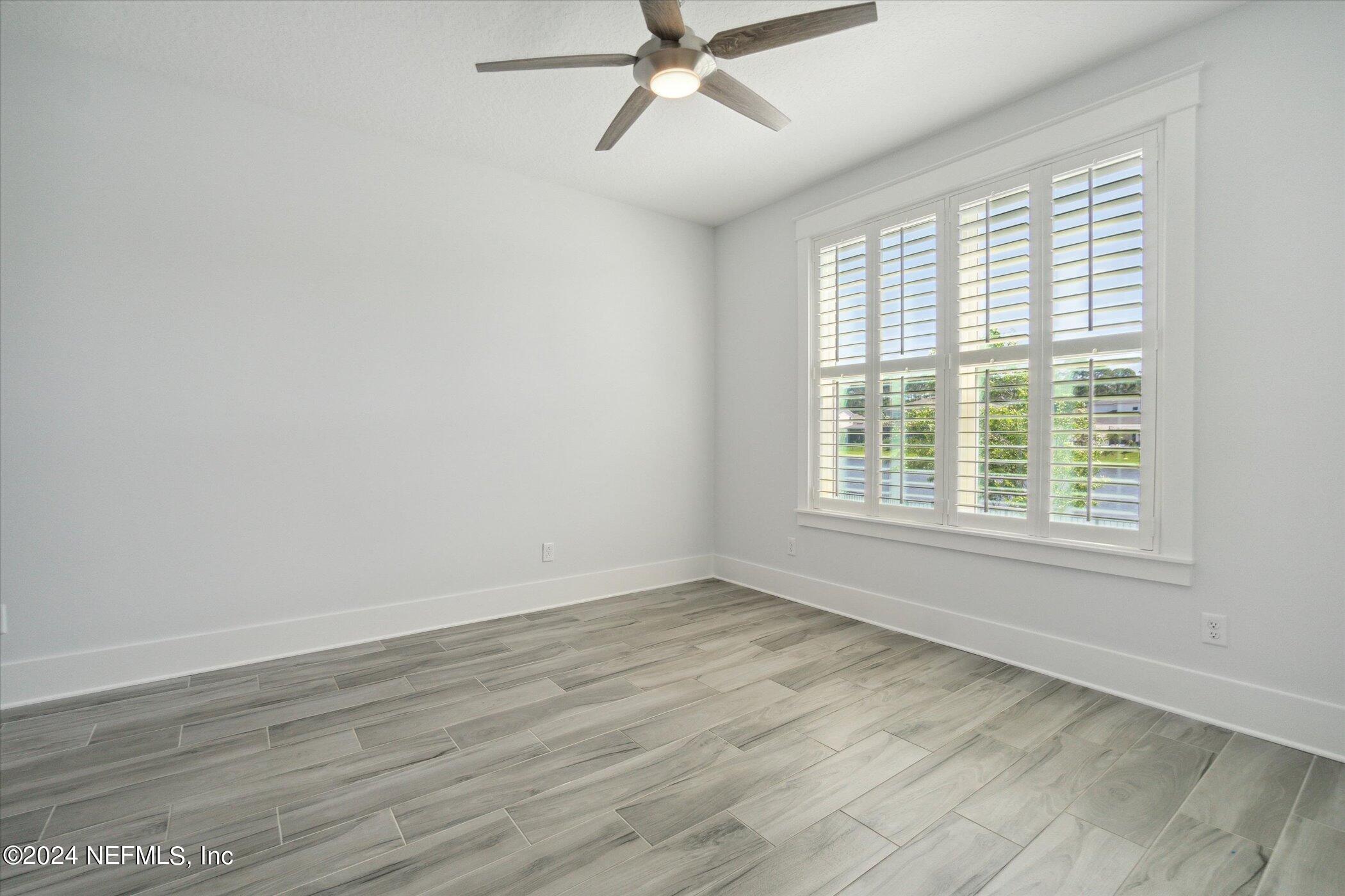 522 Old Bluff Drive Ponte Vedra, FL 32081 - Photo 52 of 93 a view of an empty room with wooden floor and a window