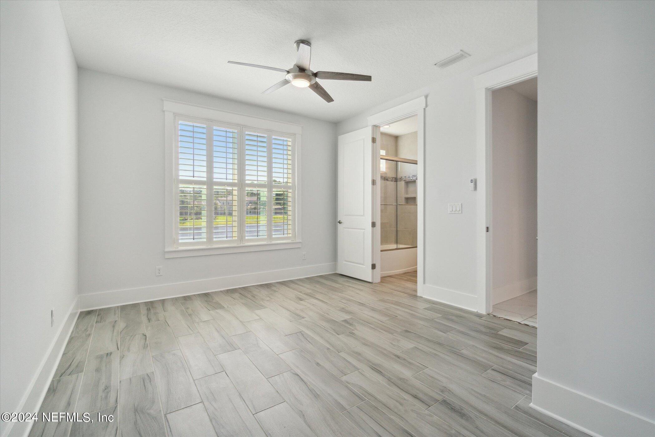 522 Old Bluff Drive Ponte Vedra, FL 32081 - Photo 53 of 93 wooden floor in an empty room with a window