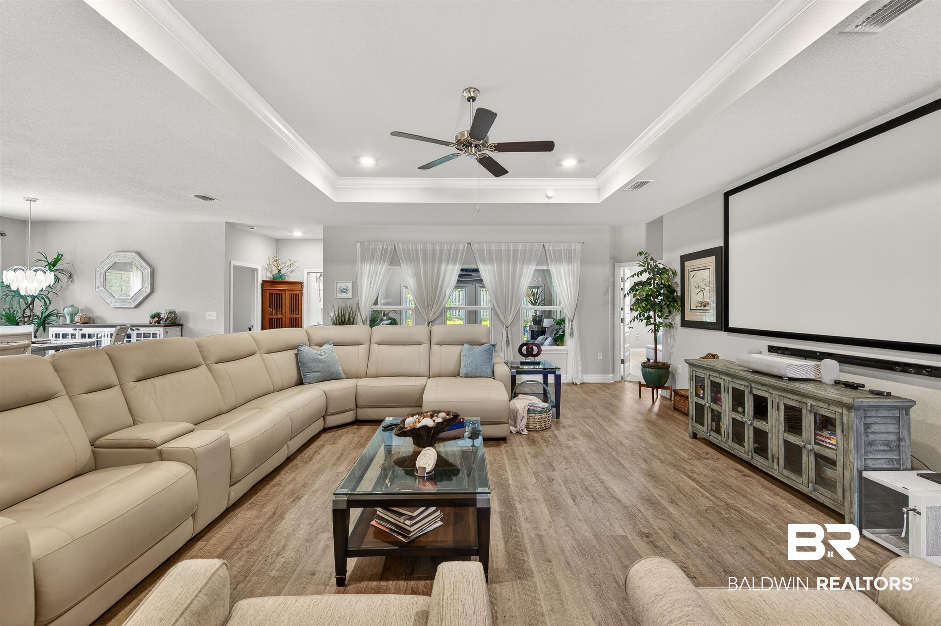 8735 Bronze Lane Foley, AL 36535 - Photo 4 of 58 Spacious living area featuring wood-finish flooring, a coffered ceiling with recessed lighting, and a ceiling fan