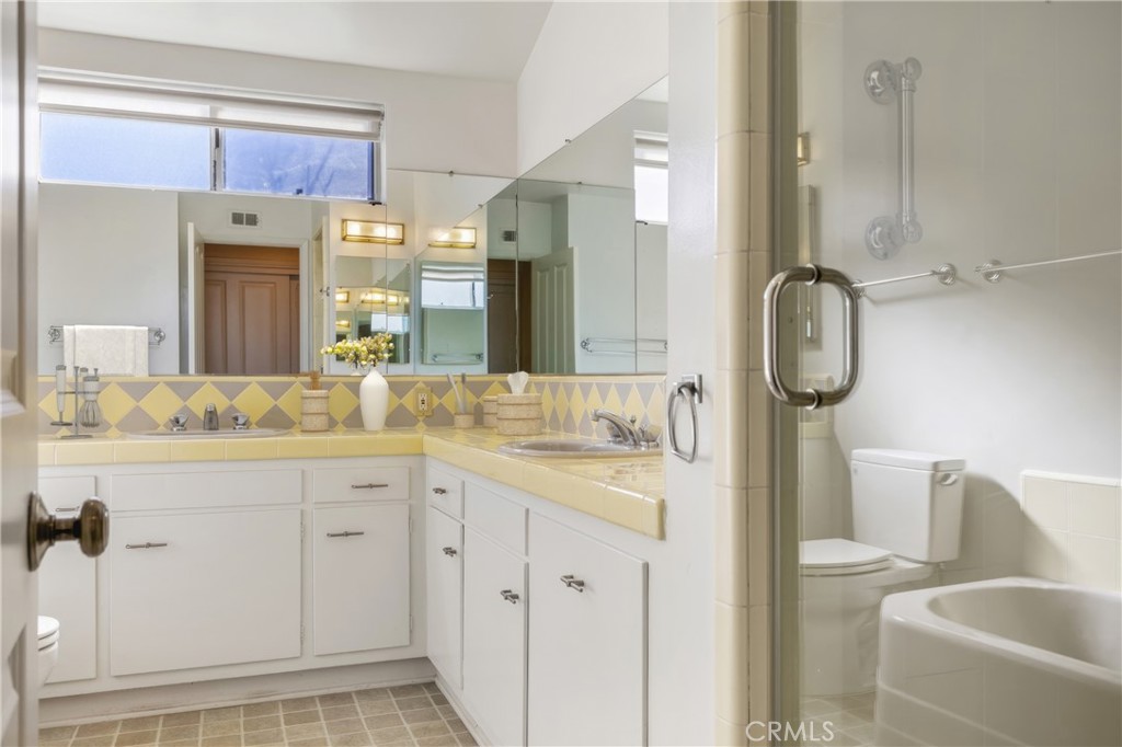 707 Luring Drive Glendale, CA 91206 - Photo 13 of 25 a bathroom with a granite countertop toilet sink and mirror