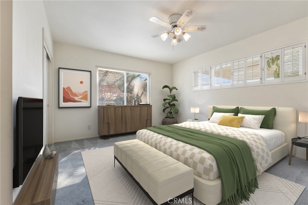 707 Luring Drive Glendale, CA 91206 - Photo 15 of 25 a spacious bedroom with a bed a couch and a large window