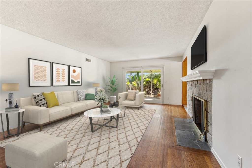 707 Luring Drive Glendale, CA 91206 - Photo 7 of 25 a living room with fireplace furniture and a flat screen tv