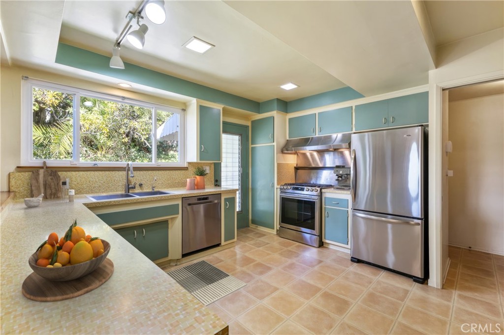 707 Luring Drive Glendale, CA 91206 - Photo 10 of 25 a kitchen with stainless steel appliances kitchen island granite countertop a refrigerator and a sink