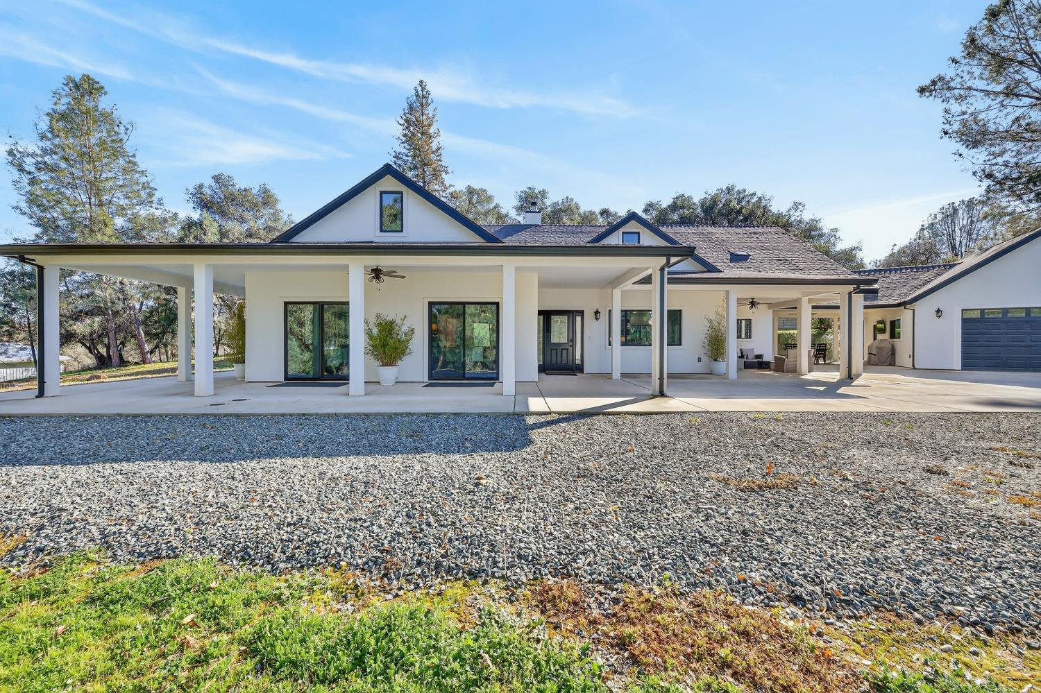 3000 Spring Hill Road Somerset, CA 95684 - Photo 2 of 94 a view of a white house with a yard and plants