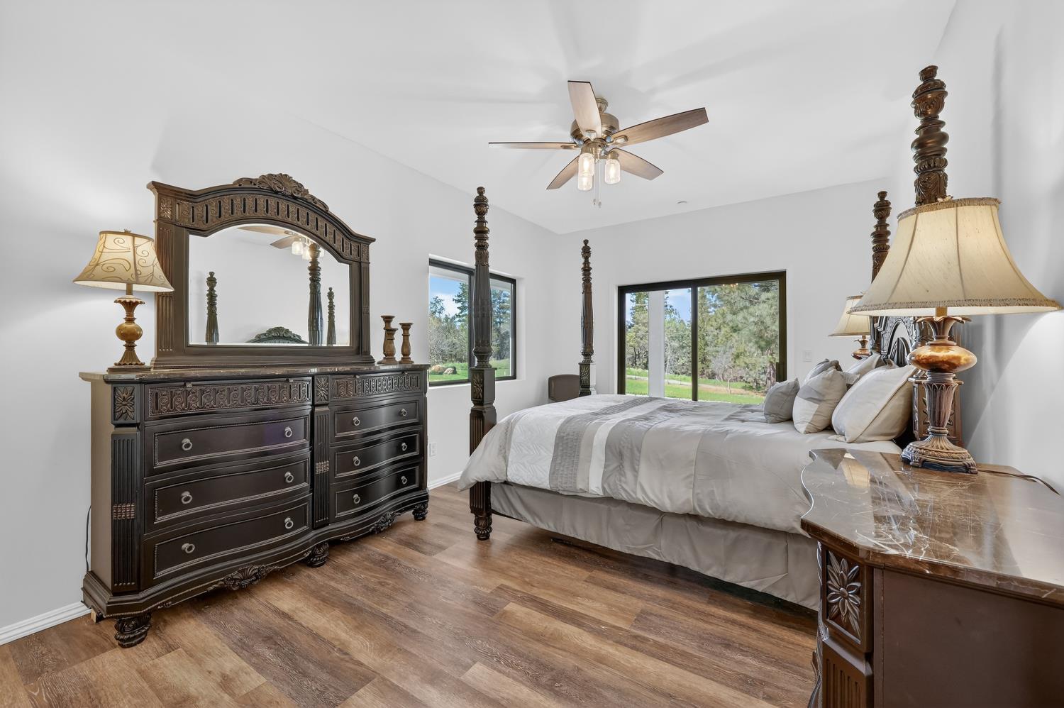 3000 Spring Hill Road Somerset, CA 95684 - Photo 28 of 94 a bedroom with a bed a chandelier and dresser