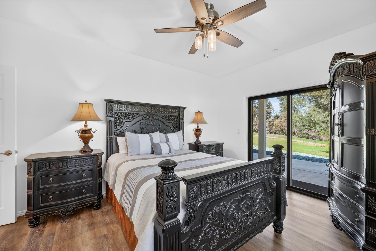 3000 Spring Hill Road Somerset, CA 95684 - Photo 32 of 94 a bedroom with a bed a chandelier and a flat tv screen on dresser