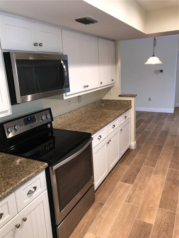7806 17th Avenue Northwest Bradenton, FL 34209 - Photo 11 of 33 a kitchen with stainless steel appliances and cabinets