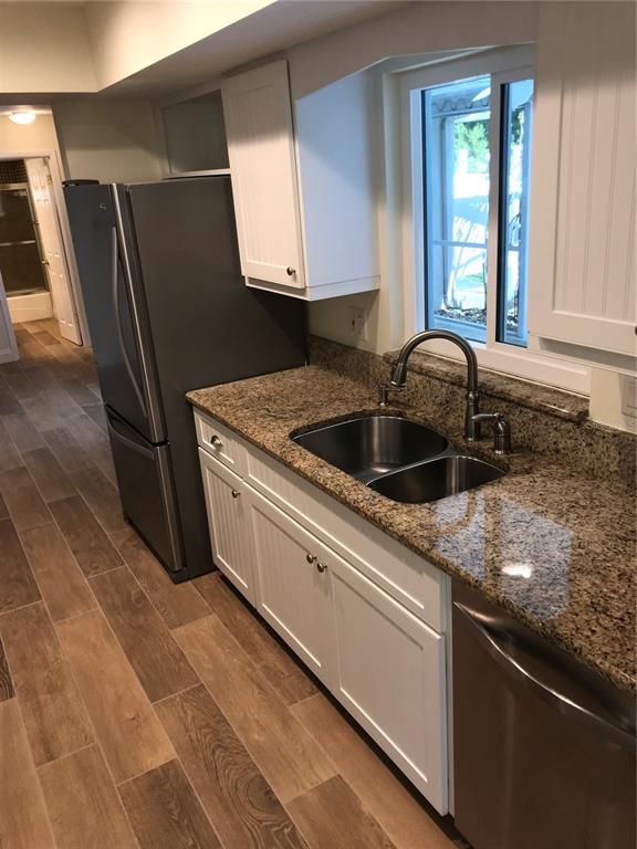 7806 17th Avenue Northwest Bradenton, FL 34209 - Photo 12 of 33 a kitchen with granite countertop a sink and a refrigerator