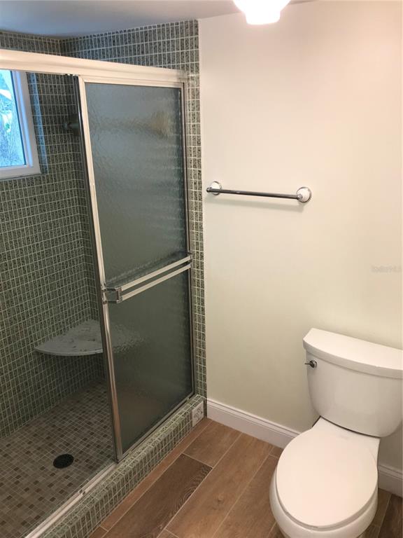 7806 17th Avenue Northwest Bradenton, FL 34209 - Photo 20 of 33 a white toilet sitting next to a shower