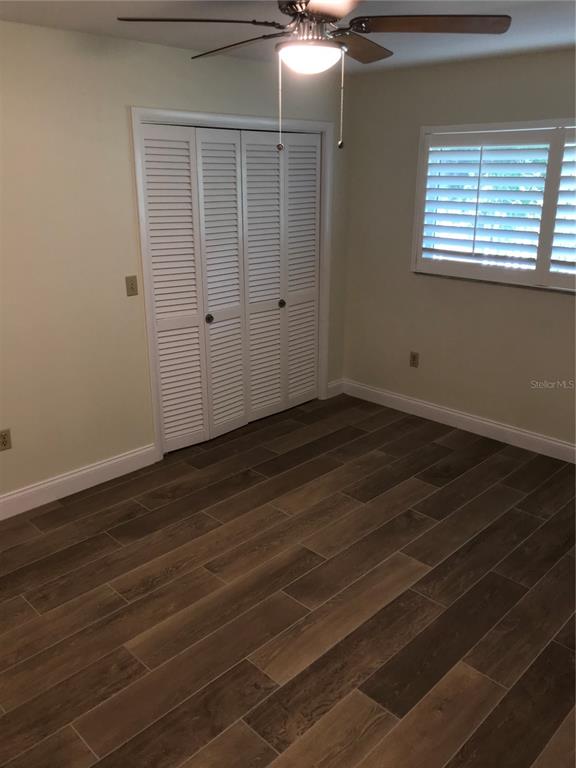 7806 17th Avenue Northwest Bradenton, FL 34209 - Photo 24 of 33 an empty room with wooden floor and windows
